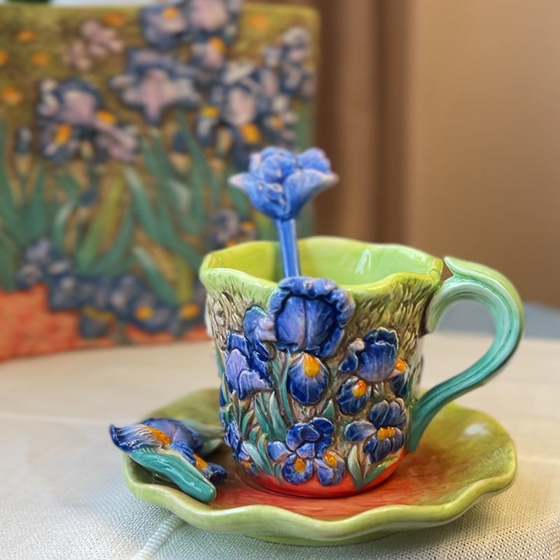 Decorative ceramic cup with floral design on a matching saucer, with a blurred Van Gogh painting in the background.