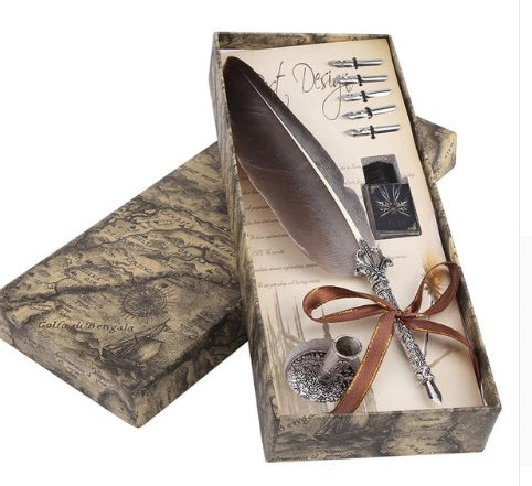 Decorative feather quill pen with ink stone in a vintage-style box