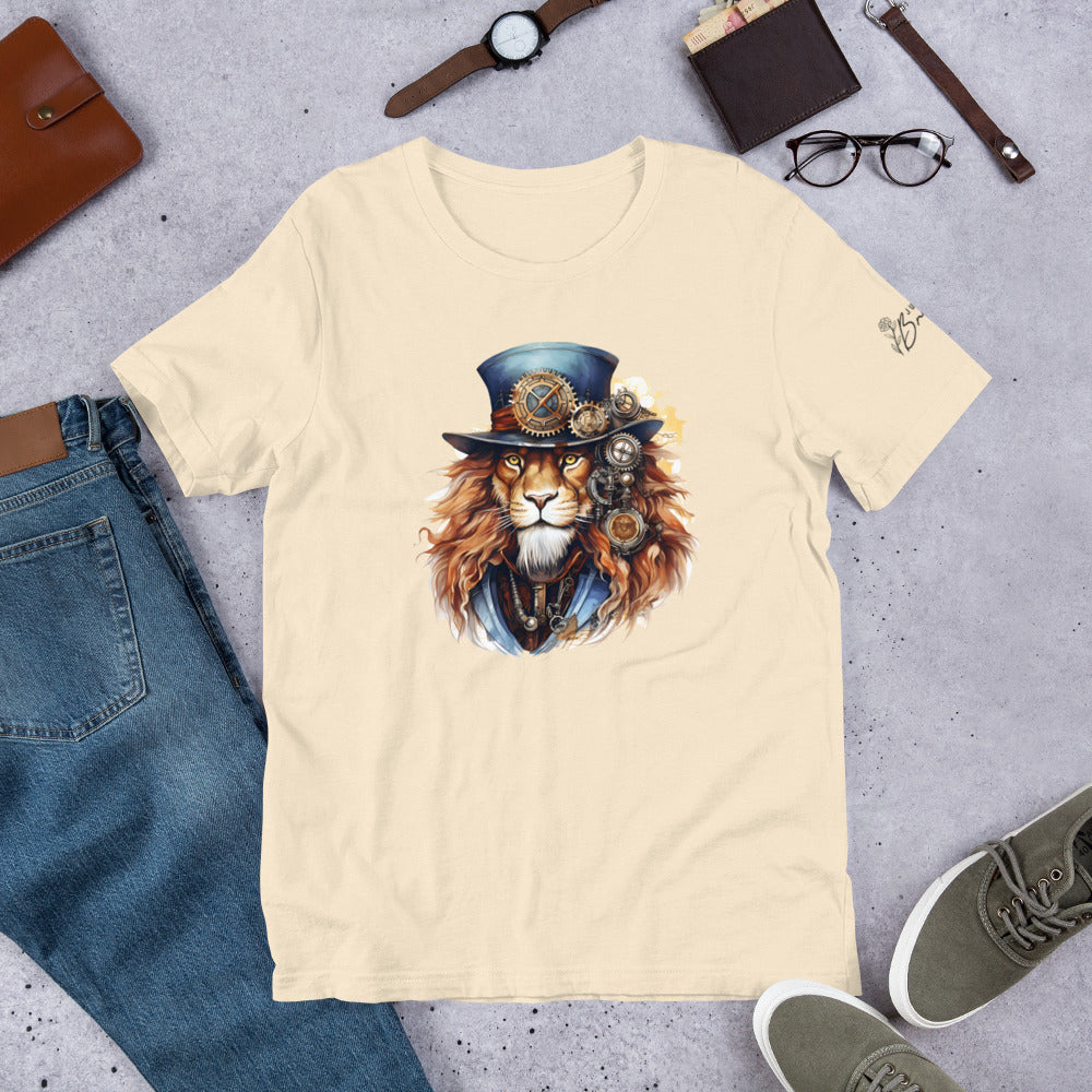 Beige t-shirt with a lion wearing a top hat and goggles design, surrounded by jeans, shoes, and accessories on a gray surface.