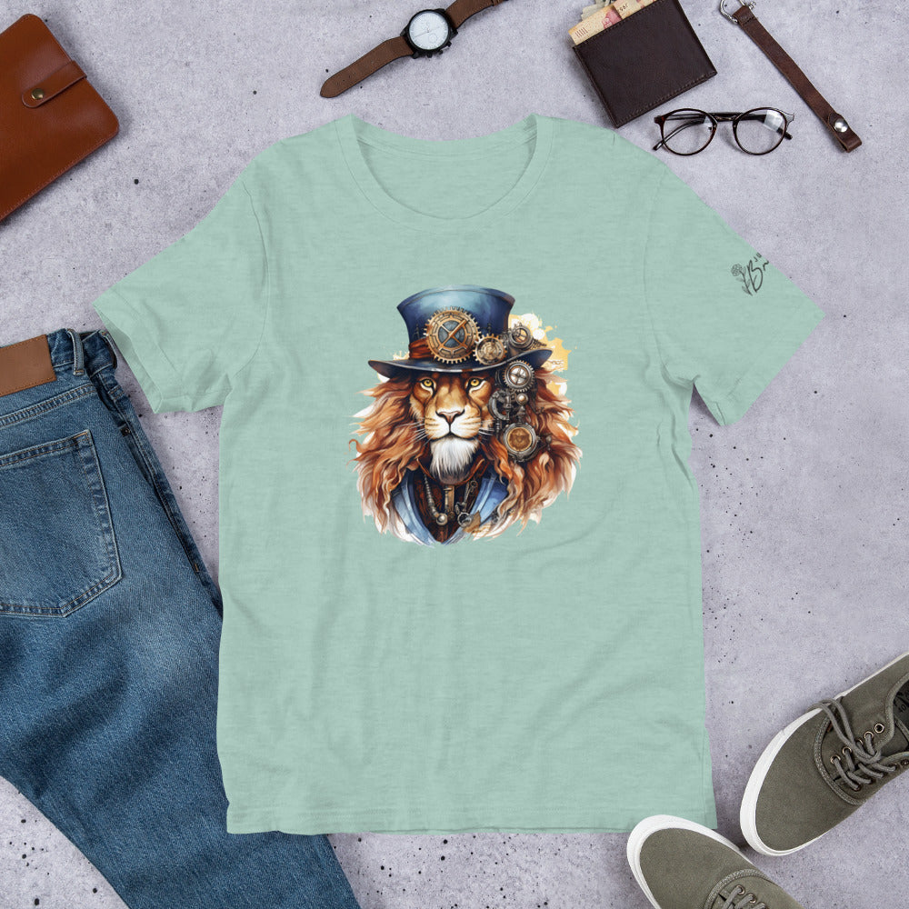 Light green t-shirt with a lion wearing a top hat and goggles design, surrounded by jeans, shoes, and accessories on a gray surface.