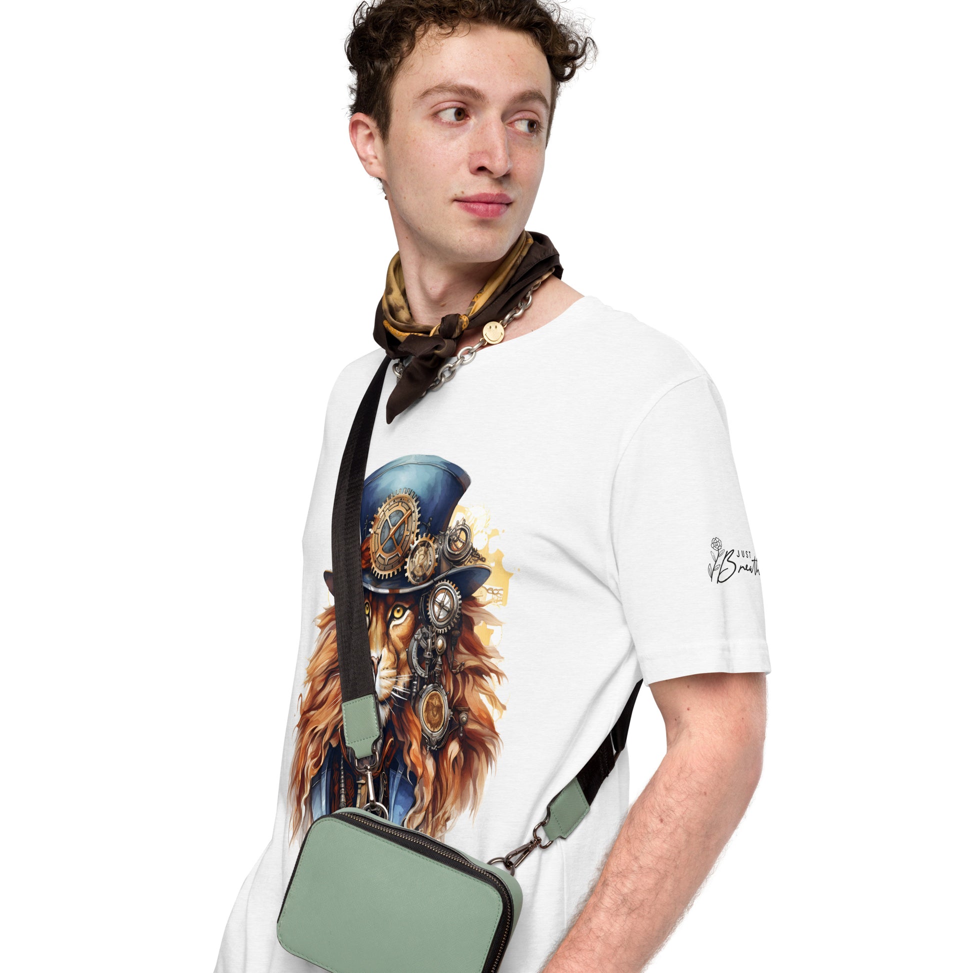 Man wearing a white t-shirt with a graphic design of a lion in a top hat and goggles, holding a green bag.